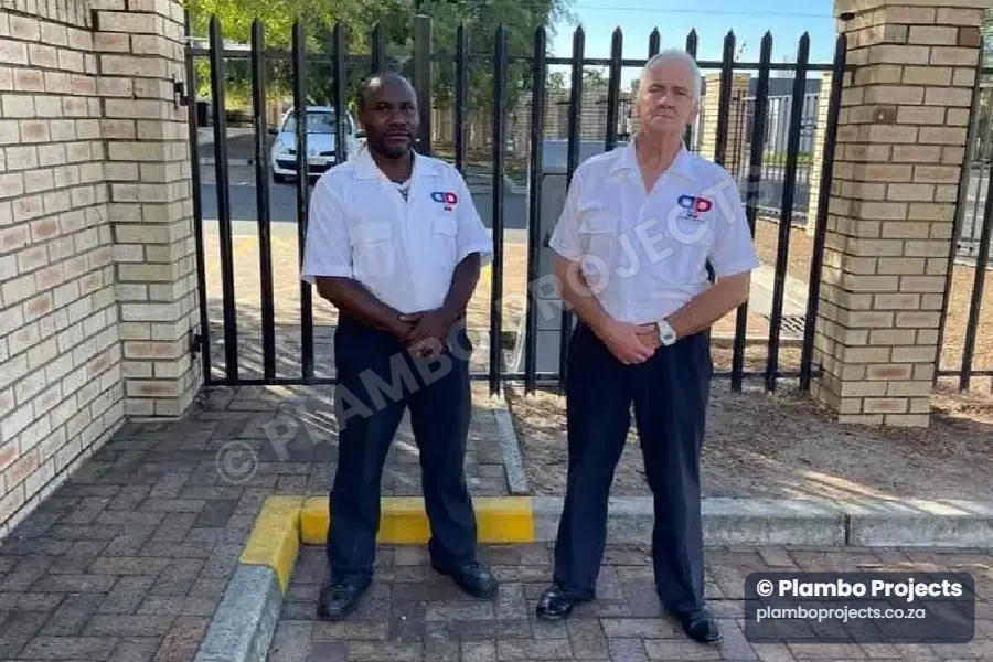 Two Plambo Projects security officers in uniform at a residential complex gate in Cape Town